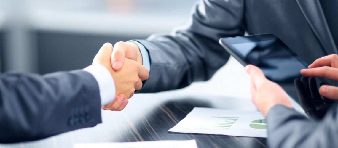 Business people shaking hands in office